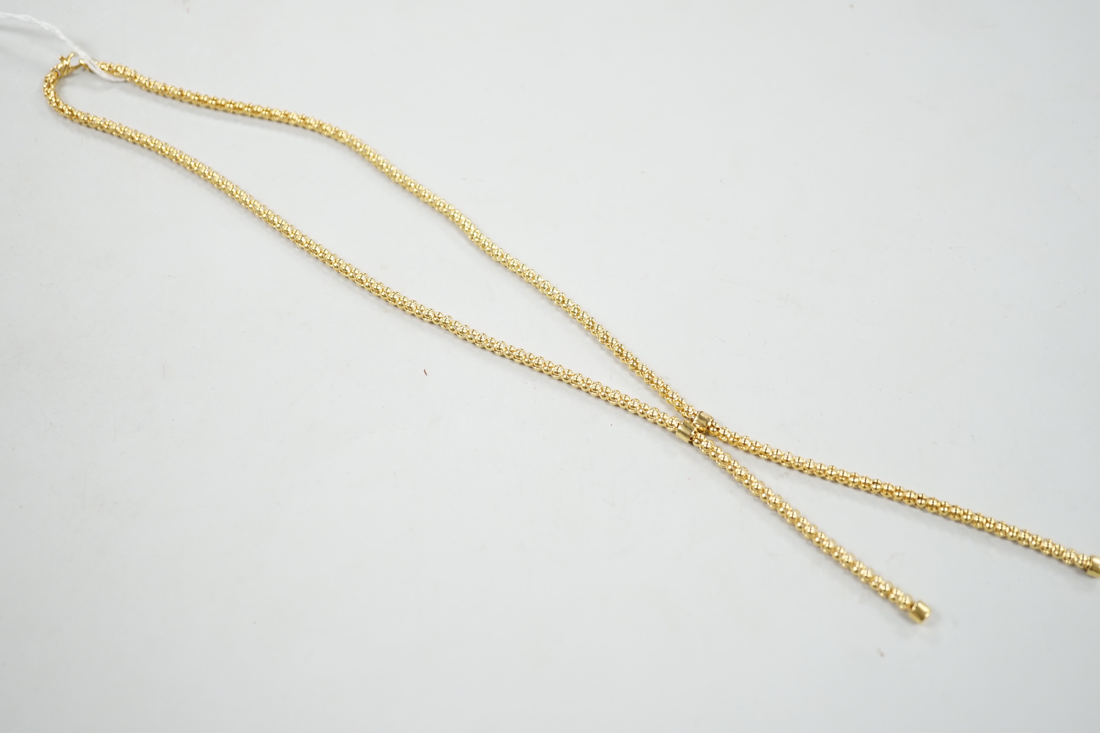 A modern 9ct gold graduated twin tassel necklace, 65cm, 15.7 grams.